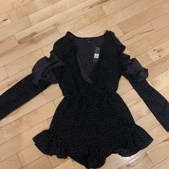 Long sleeve navy polkadot jumpsuit with cut out shoulders and frills - Picture 1 of 2